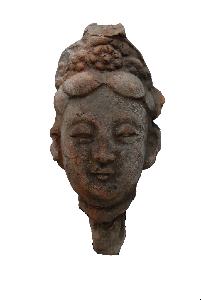 Head of a Galbinga sculpture with an updo hairstyle and floral hair ornament.